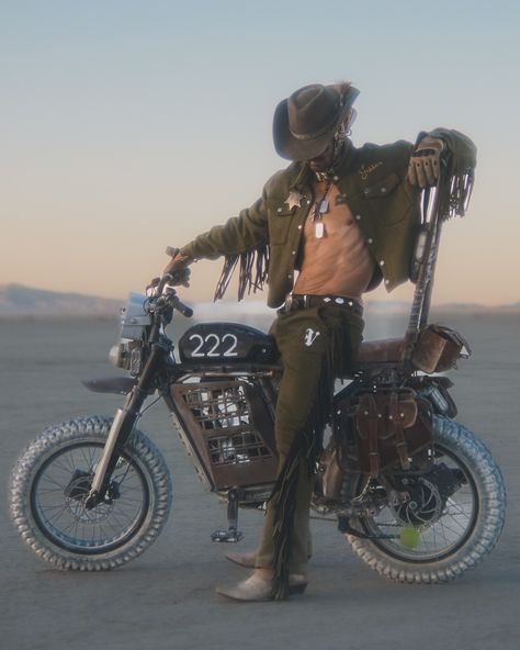 A futuristic cowboy in olive suede takes on the desert, blending classic western vibes with a modern, rebellious edge. The sheriff badge, fringe details, and rugged chaps make this a statement of fearless individuality 🤠🏜️ @jessewelle 🔥🔥 Cute Cowboy Outfits, Wasteland Cowboy, Assless Chaps Outfit, Apocalyptic Cowboy, Cowboy Outfit Aesthetic, Alt Cowboy, Cowboy Robot, Scifi Western, Futuristic Cowboy