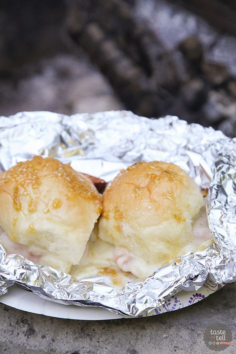 Campfire dinner in minutes! These Hot Ham and Cheese Campfire Sandwiches only take minutes to assemble. Throw them on the hot coals and dinner is done quickly and easily. Campfire Sandwiches, Tin Foil Meals, Easy Campfire Meals, Hot Ham And Cheese, Campfire Dinners, Cheap Camping, Taste And Tell, Foil Pack Dinners, Best Camping Meals