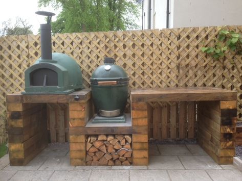 This is my outdoor cooking set up, constructed from 16 railway sleepers and oak doweling. The oven is a size large big green egg and the pizza oven is a primo 60 which has been painted with heat resistant spray to match the BGE. Slabs have been placed under each oven to prevent charing of the timber. Further work may include a cupboard or drawer system underneath. Outdoor Kitchen Sleepers, Outdoor Kitchen With Green Egg And Pizza Oven, Outdoor Pizza Oven Set Up, Oak Outdoor Kitchen, Green Egg Station, Outdoor Bbq And Pizza Oven Ideas, Timber Outdoor Kitchen, Bge Outdoor Kitchen, Egg Bbq Outdoor Kitchens