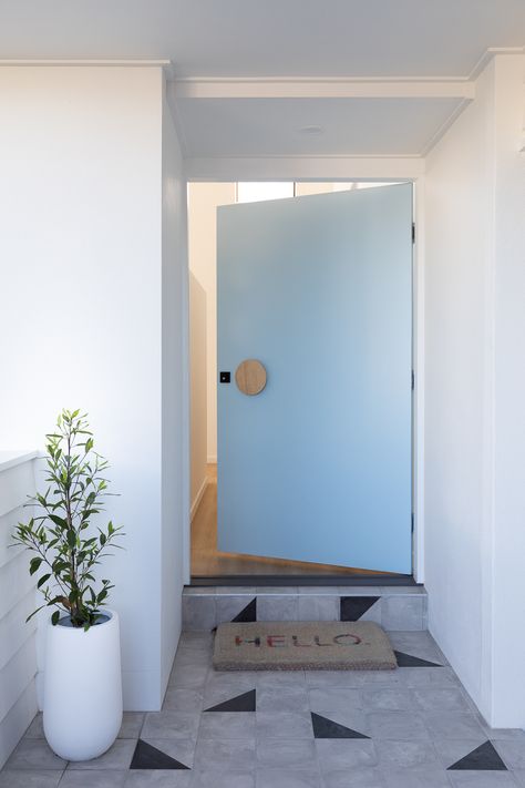 A blue front door welcomes visitors to the Burleigh Beach Retreat. Colours: Door is Template Half and house is Snowy Mountains 1/4 by @duluxaustralia Front door handle: @auburnwoodturn Hello door mat: @livingby_design Tiles: @tilecloud0487 Pot: @evergreencollectiveau Photo: Elouise van Riet-Gray #bluefrontdoor #scandifrontdoor #scandicoastal #beachhouse Blue Doors Front Entrance, Danish Summer House, 1980s House, Beach House Renovation, Beach House Colors, Blue Front Door, Design Tiles, Kit Kemp, Scandi Interiors