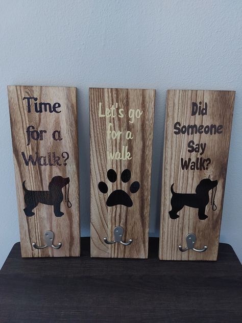 Keep things organized with this cute dog leash holder. We have a few different designs to choose from. When placing your order, just specify which saying you would like and if there is a different color vinyl you would like. As long as we have the color available or can get it, we will be happy to accommodate your color choice. Dog Treat Holder Diy, Dog Signs Wooden, Dog Hooks For Leash, Trending Wood Crafts To Sell 2023, Diy Dog Stuff To Sell Craft Ideas, Dog Gifts Diy, Things To Engrave, Dog Leash Holder Diy, Diy Pet Crafts