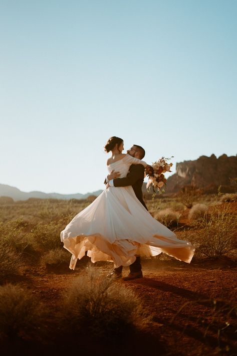 Fun & Creative Wedding Day Photo Poses and Ideas brides wears an off the should long flowy wedding dress. The groom holds her in his arms and spins her around letting her dress twirl perfectly. Wedding Photo Pauses, Spin Wedding Photo, Wedding Creative Photography Poses, Bride And Groom Twirl, Interesting Wedding Photo Ideas, Wedding Twirl Photo, Groom Spinning Bride, Whimsical Wedding Photoshoot, Rustic Wedding Photos Ideas