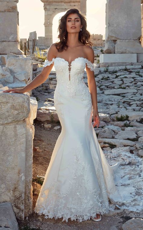 brown hair model in an off the shoulder mermaid gown with luxious lace and a fitted shape. With a ruins background Eddy K Wedding Dress, Nature Wedding Dress, Eddy K, Timeless Wedding Dress, Pearl Beading, Women Bride, Wedding Gowns Mermaid, Designer Bridal Gowns, Dream Wedding Ideas Dresses