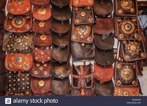 Download this stock image: Moroccan leather goods and bags with metal ornaments at a souk or market by the tannery in Fes, Morocco. - PDEWTW from Alamy's library of millions of high resolution stock photos, illustrations and vectors. Crafts From Around The World, Fes Morocco, Metal Ornaments, Leather Portfolio, Moroccan Leather, San Blas, Ikat Fabric, Metal Ornament, Lace Making