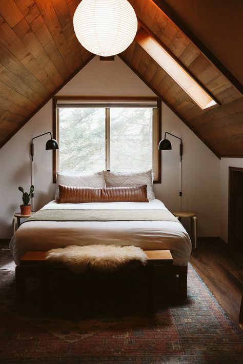 Queen bed with white sheets and leather lumbar pillow under open window with PNW Oregon forest views at top of a-frame in cozy cabin Mt. Hood airbnb West Coast Cabin Interior, Cabin Modern Art, A Frame Cabin Bedroom Ideas, A Frame Master Suite, Modern Cabin Interior Bedroom, Simple Cabin Bedroom, Mountain Cabin Aesthetic Bedroom, A Frame Cabin Bedroom, Pnw Cabin Aesthetic