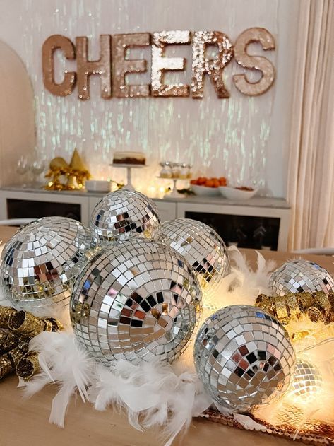 Sparkly Silver and Gold New Years Eve Party Ideas. DIY a glittering New Year's Eve with a sequin 'CHEERS' sign, a silver and gold table runner, and a festive buffet. New Years Eve Party Home, Winter Wonderland New Years Eve Party, New Years Eve Party Ideas Decorations Table Settings, New Years Eve Aesthetic Party, New Years Eve Party Ideas For Adults, Disco New Years Eve Party, White And Gold Christmas Party, Colorful New Years Eve Party, New Years Eve Engagement Party