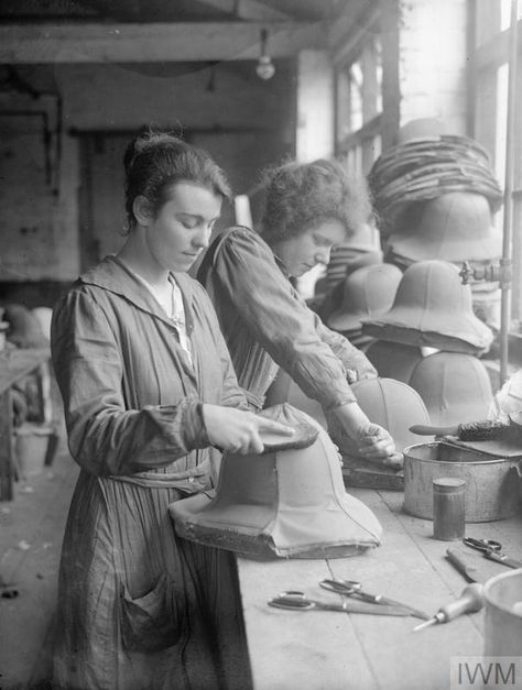 Two women workers cover Army tropical helmets for the firm of Messrs E Day in St Albans. A pile of completed helmets can be seen on the bench beside them. 1918. Ww1 Women, Photography History, Women Working, E Day, St Albans, Historical Images, Charles Bukowski, Bukowski, Working Woman