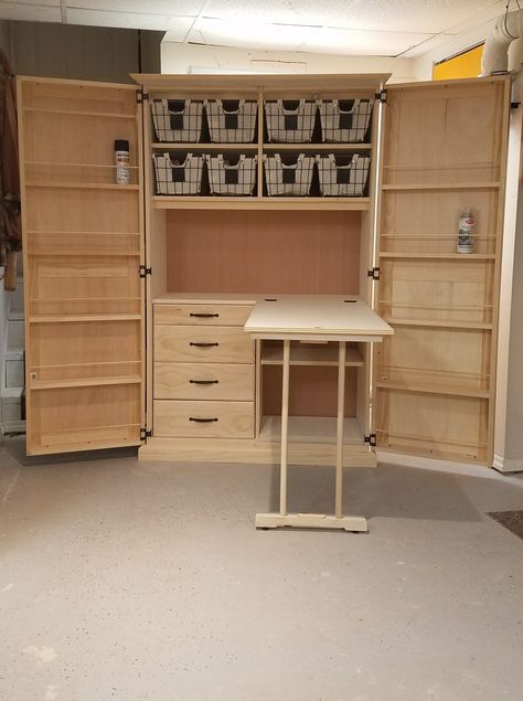 Crafting cabinet with fold out work table. Craft Cabinet Organization Diy, Craft Storage With Fold Out Table, Sewing Cupboard Cabinets, Armoire Sewing Cabinet, Diy Craft Armoire With Fold Out Table, Fold Out Sewing Table, Craft Room Custom Cabinets, Sewing Armoire Cabinets, Crafting Armoire With Fold Out Table