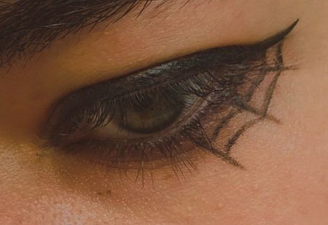 Warm colored photograph of Hazel eye with black eyeliner in the shape of a spiderweb Cobweb Eyeliner Simple, Spiderweb Liner, Halloween Eyeliner Spiderweb, Spiderweb Eyeliner, Spider Web Eyeshadow, Halloween Eye Makeup Spiderweb, Makeup Tattoos, Make Up Inspo, Brow Makeup