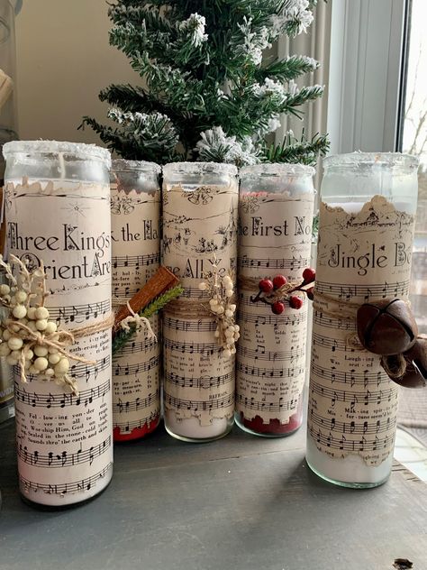 Please see below for colors, add your request in the personalization note. These 8in tall candles are perfect for your holiday decor! Choose between 7 vintage sheet Christmas music types and varying colors. The sheet music is hand dyed and encrusted on the candles and every strung on addition is specifically curated to add on extra pizazz to each candle. Deck The Halls - 2 Red First Noel - 1 Red Away in a Manger - 1 Red Jingle Bells - 2 White 3 Kings - 1 White Silent Night - 2 Red O Come All Ye Lds Christmas Party Table Decorations, Sheet Music Christmas Crafts, Sheet Music Decorations, Diy Christmas Candles Decorations, Christmas Pillar Candles, Country Christmas Centerpieces For Table, Christmas Centerpieces Simple, Christmas Centerpiece With Candles, Christmas Tea Table Decorations