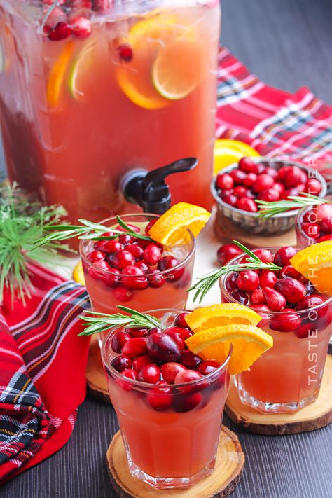 If you're looking for an easy large-format cocktail for holiday parties and Christmas entertaining, this holiday punch is for you. Large Drink Dispenser Recipes, Holiday Punch Bowl Cocktails, Drink Dispenser Cocktail Recipes, Dispenser Cocktail Recipes, Christmas Drink Dispenser, Christmas Cocktail Pitcher, Alcoholic Punch Recipes For A Crowd, Christmas Cocktail Punch, Adult Christmas Punch