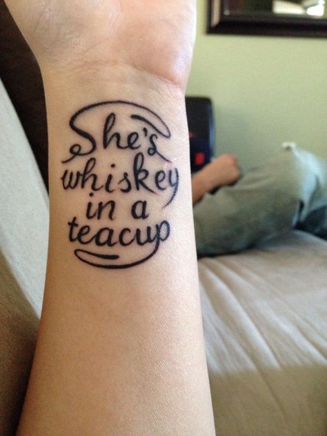 "She's whiskey in a teacup." I love this tattoo. I would get it with a tiny teacup somewhere on my back - I feel that this song lyric describes my personality accurately; my husband agrees. I also like the other lyric from this song that says a "swan and a pistol," that would make for an awesome tattoo visually as well. Love the lyrics of "Black Market Baby," by Tom Waits. Whiskey Tattoo Design, Whiskey Tattoo Ideas, Whisky Tattoo, Tennessee Whiskey Tattoo, Whiskey Glass Tattoo Ideas, Whiskey In A Teacup Tattoo, Shes Whiskey In A Teacup Tattoo, Whiskey Tattoo, Tom Waits Tattoo