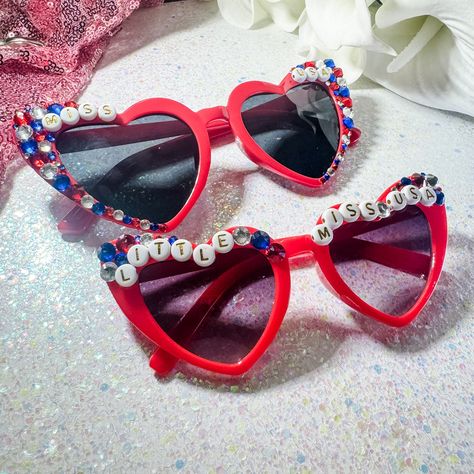 🌟 From Mom to Mini: Our ‘Miss USA’ and ‘Little Miss USA’ sunglasses are here! 🕶️💖 Perfect for matching vibes this summer. Whether you’re stepping out with your little one or shining on your own, we’ve got you covered. Tap to shop now and follow us for more patriotic chic! 🇺🇸✨ #MissUSA #LittleMissUSA #MommyAndMe Patriotic sunglasses Miss USA sunglasses Little Miss USA sunglasses Mommy and me accessories Fourth of July eyewear Red heart sunglasses Rhinestone sunglasses Match with your min... Fourth Of July Sunglasses, Red Heart Sunglasses, Sunglasses Rhinestone, Diy Sunglasses, Patriotic Accessories, Beaded Sunglasses, Summer Fashion Accessories, Mom And Daughter Matching, Hair Business