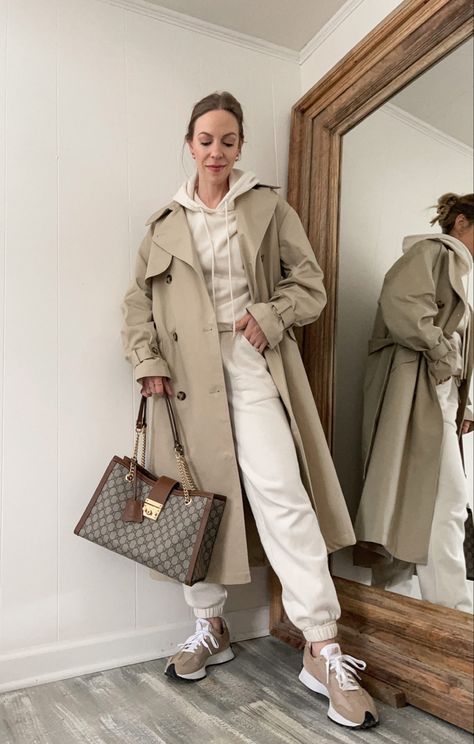 Light brown trench coat styled casually Tracksuit And Coat Outfit, Beige Sweatsuit Outfit, Sweatshirt Trench Coat Outfit, Light Trench Coat Outfit, Light Brown Trench Coat Outfit, Light Brown Coat Outfit, Beige Coat Outfit Classy, Brown Trench Coat Outfit, Beige Coat Outfit