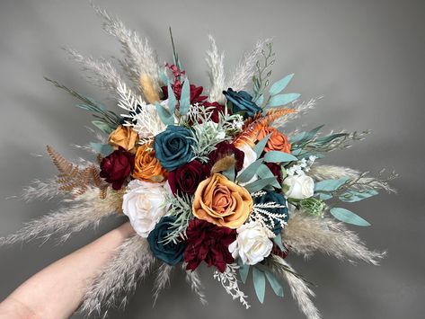 We are a Full Service Florist 💐 That means that we can make and customize anything!💕 Every single item in your order will be matched to the same style as the Bridal Bouquet on the photo, unless you ask otherwise.🥰 You can customize any item (size, color, flowers, accents) or we can make items that are not even listed For example you can request groom's boutonniere to stand out from the rest of them 🤗 We will be sending you photos of all the items for confirmation! Nothing gets shipped unless Dark Teal And Rust Orange Bouquet, Dark Teal Wedding Bouquet, Wedding Dark Teal, Dark Teal And Rust Orange Wedding, Orange And Blue Wedding Colors, Terracotta Bridesmaids, Teal Fall Wedding, Bridesmaids Burgundy, Burnt Orange Bouquet