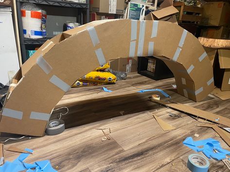 Arch was made from 10x10 cardbord boxes, triangular pieced hot glued together at joints. Layed flat and traced over a large corogated card board. Hot glued and taped to secure. Cardboard Arch, Diy Halloween Props, Christmas Classroom Door, Cardboard Creations, Halloween Props Diy, Christmas Boxes, Display Boards, Arched Doors, Parade Float