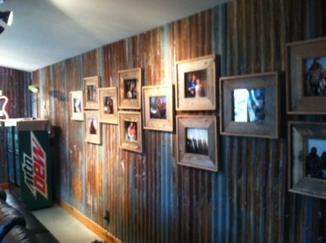 Old barnwood picture frames on a rusted tin wall from a barn roof. Found at the krugerfarms.com lodge. Barn Tin Wall, Barnwood Picture Frames, Tin Interior, Barn Remodel, Barn Tin, Barn Wood Picture Frames, Corrugated Tin, Tin Wall, Barn Wood Crafts