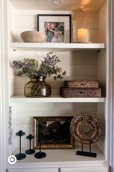 Spruce up your space with a modern-rustic vibe you’ll love for seasons to come. Mix & match textured decor accents. Add a glass vase with faux flowers to make your space extra cozy. P.S. Add these to your entryway, bookshelf or your dresser to liven up any corner. Fall Shelf Decor Ideas, Built In Shelf Decor, Cabinet Styling, Apartment Finds, Shelf Decor Living Room, Living Room Built Ins, Styling Shelves, Room Vibes, Decorating Bookshelves