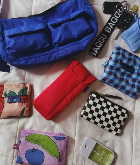 ⊹ flat lay ⊹ ⊹ baggu cargo shoulder bag in lapis ⊹ baggu puffy eyeglasses case in candy apple ⊹ baggu standard reusable in blue wavy gingham ⊹ baggu baby reusable in strawberry ⊹ baggu puffy earbud case in cornflower ⊹ baggu keychain in black & white ⊹ baggu small flat pouch in still life #baggu #baggubag #wimb #whatsinmybag #baglovers @baggu #whatsinmybaggu #baggugirl #bagguandyou #baggubesties #bagguinuse #bagguinthewild #flatlay #baggulapis #baggucandyapple #touchland #baggufall2024 Baggu Puffy Glasses Case, Baggu Keychain, Earbud Case, Aesthetic Backpack, Eyeglasses Case, Flat Pouch, Backpack Decoration, Bag Aesthetic, Fashion Things