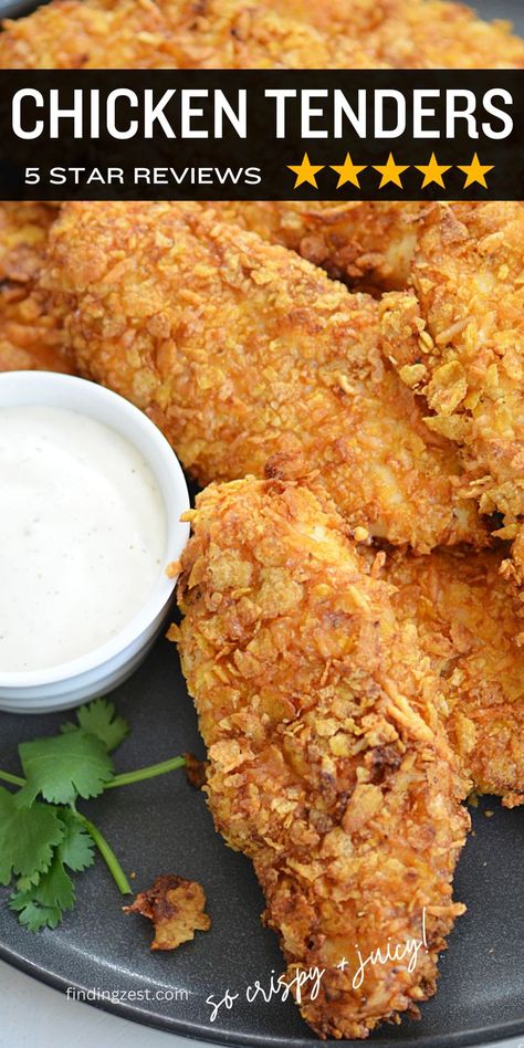 Golden brown chicken tenders with a crispy corn flake coating on a large black round platter with a dish of ranch dressing. Chicken Tenders Corn Flakes, Crispy Chicken Tender Recipes, Corn Flake Chicken Tenders, Baked Fried Chicken Tenders, Crispy Air Fryer Chicken Tenders, Air Fryer Recipes Chicken Tenders, Crispy Air Fryer Chicken, Cornflake Chicken, Baked Fried Chicken