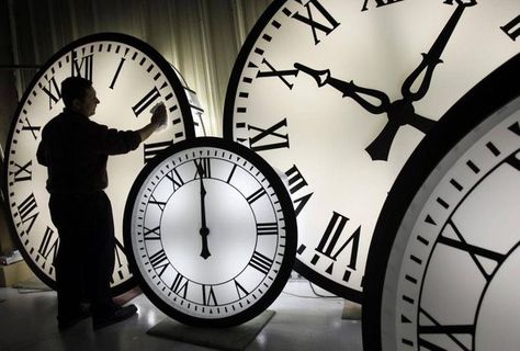 Electric Time Co. employee Walter Rodriguez cleans the face of an 84-inch Wegman clock at the plant in Medfield, Mass. Thursday, Oct. 30, 2008. Washington State lawmakers have proposed a bill that, if passed, could mean a change in time zones driving south to Seattle from Vancouver.  Elise Amendola/AP Clocks Forward, Large Clocks, Intercultural Communication, Spring Ahead, Time Keeper, Daylight Savings, Time Clock, Daylight Savings Time, Working People