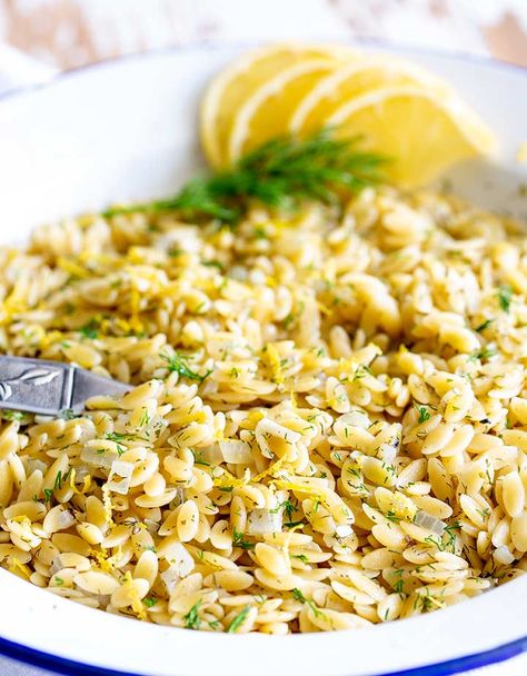 This Greek Orzo with Lemon and Herbs makes the best side dish for fish or chicken. It is quick to cook and packed with flavor. In under 15 minutes, you can have this fresh and delicious pasta side dish ready for the table. I find that kids love the little pasta too! You can serve it hot or cold and it tastes wonderful the next day, making it great for lunchboxes. #greekfood #easysidedish #quickpasta #pastasidedish Greek Lemon Orzo, Greek Orzo, Lemon Orzo, Orzo Recipe, Side Dishes For Fish, Vegetarian Pasta Recipes, Orzo Recipes, Greek Dishes, Steak Side Dishes