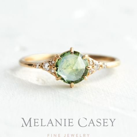 The Honeydew Rose Cut Sapphire Lady's Slipper features a pale green rose cut Montana sapphire set in 14k yellow gold and accented by sparkling white diamonds. Find this delicate, unique engagement ring at melaniecasey.com! Pale Sapphire Engagement Ring, Pale Green Engagement Ring, Earth Engagement Rings, Creative Engagement Rings, Rings Delicate, Jewelry Alternative, Promise Jewelry, White Gold Bridal Set, Rose Gold Promise Ring