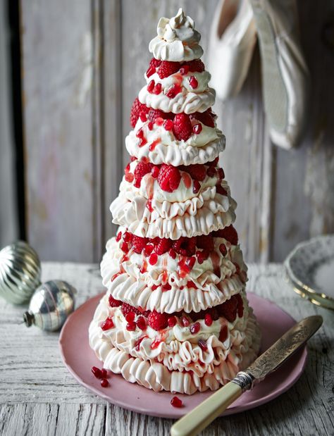 Our jewelled pavlova tower recipe makes a striking showstopper. Packed with cream and raspberries, this elegant meringue bake will make a superb Christmas Day dessert Christmas Pavlova, Pavlova Dessert, Pavlova Cake, Holiday Desserts Christmas, Pavlova Recipe, Christmas Cakes, Xmas Food, Christmas Cooking, Food Cakes