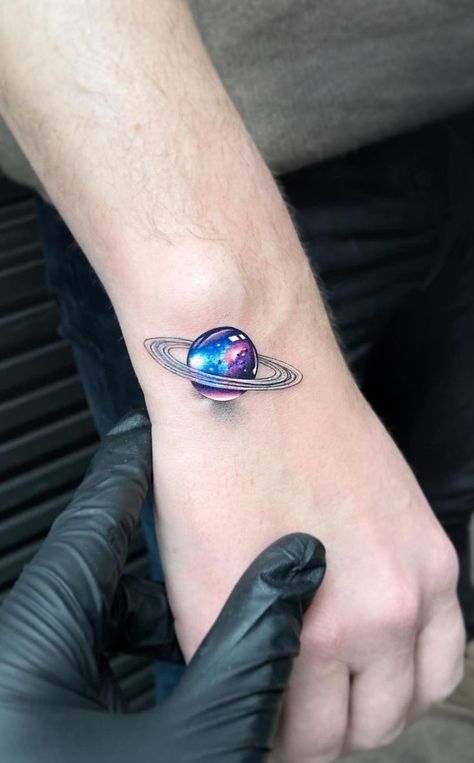 Creative Saturn Tattoo With Galaxy Colors Watercolor Galaxy Tattoo, Small Colorful Tattoos, Astronomy Tattoo, Circular Tattoo, Cosmic Tattoo, Saturn Tattoo, Colored Tattoo Design, Uv Tattoo, Universe Tattoo