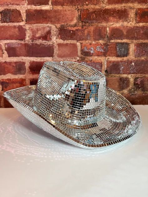 A silver cowboy hat sitting on top of a white table Disco Ball Boots, Beyonce Disco, Doralee Rhodes, Sparkly Cowgirl Hat, Disco Ball Hat, Cowboy Hat Disco Ball, Disco Tiles, Disco Cowboy Hat, Disco Hat