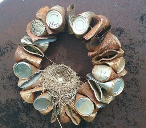 This rusty, country style wreath may not be everyone’s cup of tea, but it looks right at home in my rural garden, so I’m sharing it just for fun! While going through old garden magazines last year, I caught just a glimpse of the side of a tin can wreath hanging in the picture of a garden, so of course I felt the need to make one. I threw a bunch of dog food cans in a tub of water to soak outside for a few weeks and start the rusting process. After dumping the cans to dry, I creased th… Can Wreath, Fall Wreaths Diy, Recycled Tin Cans, Fall Decor Diy Crafts, Recycled Tin, Diy Fall Wreath, Pallet Crafts, Wreaths Diy, Wreath Forms