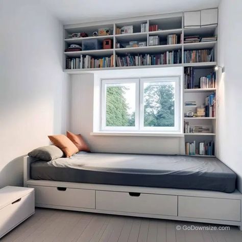 This tiny bedroom has wall shelves above the bed as a practical and space-saving storage solution. Shelves Above Bed, Bedroom Shelving Ideas, Tiny Bedroom Storage, Room Divider Ideas Bedroom, Shelf Above Bed, Bedroom Shelving, Small Boys Bedrooms, Small Kids Bedroom, Wall Wardrobe Design