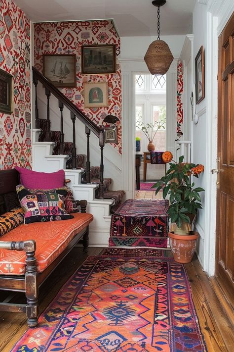 The Dynamic Boho Entryway is characterized by bold patterns and vivid designs that create an engaging and lively entrance. This boho entryway idea features vibrant wallpaper, colorful rugs, and decorative pillows with unique prints to make a strong statement. Simple furniture allows the bold patterns to stand out, complemented by small, vibrant decor items. Ideal for those who embrace bold, eye-catching designs to define their space. Click for more Dynamic Boho Entryway ideas. Boho Entryway Ideas, Eclectic Hallway, Boho Entry, Mediterranean Boho, Vibrant Wallpaper, Boho Entryway, Bright Rugs, Vibrant Decor, Wallpaper Colorful