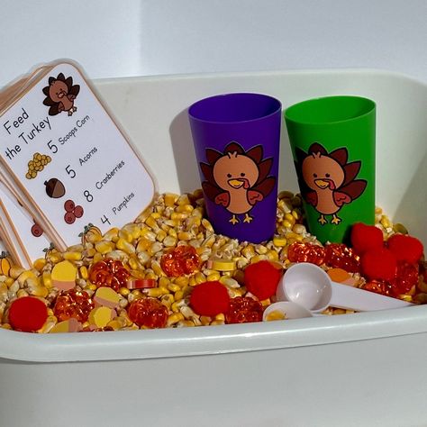 "Feed some hungry turkeys with this thanksgiving inspired sensory bin. Use the direction card to add what you need for each turkey dinner, then add it to the turkey cup. Work on number identification and counting skills as you feed the turkey. Includes enough for two children to play! Perfect for a classroom or home sensory bin.  Each set includes: 2 lbs of large kernel corn  15 pumpkins 15 acorns 15 pom pom \"cranberries\" 2 Turkey cups  2 scoops 16 'recipe' cards" Sensory Bin Thanksgiving, Thanksgiving Gift For Preschoolers, Turkey Sensory Bin Preschool, Thanksgiving Sensory Play, Thanksgiving Sensory Bin Toddlers, Thanksgiving Theme Sensory Bin, Feed The Turkey Sensory Bin, Oatmeal Sensory Bin, Turkey Sensory Bin