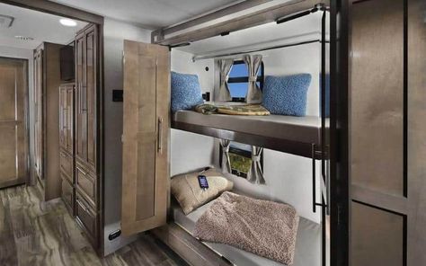 When it comes to RV's with bunkhouses, Class A RVs are incredibly luxurious and substantial in size, making them exceptional options for families looking to travel or live on the road. These motorhomes offer substantial living space with all the amenities one could wish for, including a kitchen with appliances, flat-screen T.V.s, and full bathrooms. Whether you're traveling with young children, teenagers, or a few adults, adequate sleeping space is essential to factor in when buying ... Diy Cargo Trailer, Kitchen With Appliances, Cargo Trailer Camper Conversion, Cargo Trailer Conversion, Rv Air Conditioner, Cargo Trailer Camper, Small Travel Trailers, Class C Rv, Class A Motorhomes