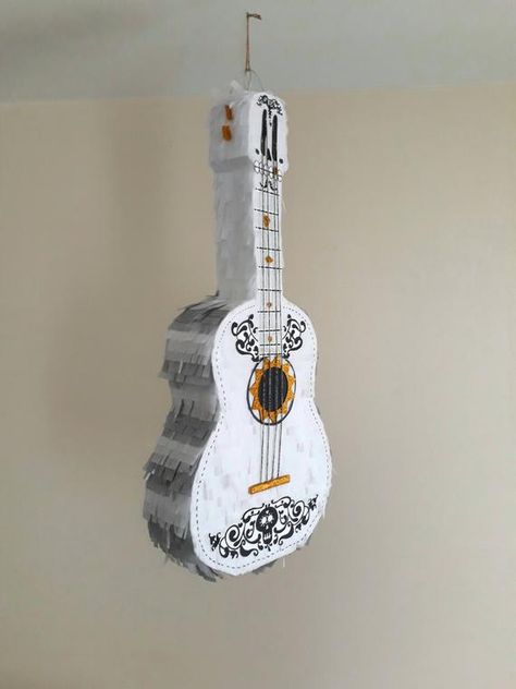 Disney Coco party supplies - Guitar Pinata | CatchMyParty.com #catchmyparty  #partyideas #disneycoco #coco #fiesta # partysupplies #dayofthedead  #diadelosmuertos #mexico #pinata #cocopinata #cocoguitar #cocopartydecorations #cocopartydecor #miguelcoco #cocoinvitation #cocoparty  #boybirthdayparty Disney Coco Party, Guitar Pinata, Coco Party, Disney Coco, Halloween School Treats, Pixar Coco, Piñata Ideas, Twins 1st Birthdays, Halloween Treats Easy