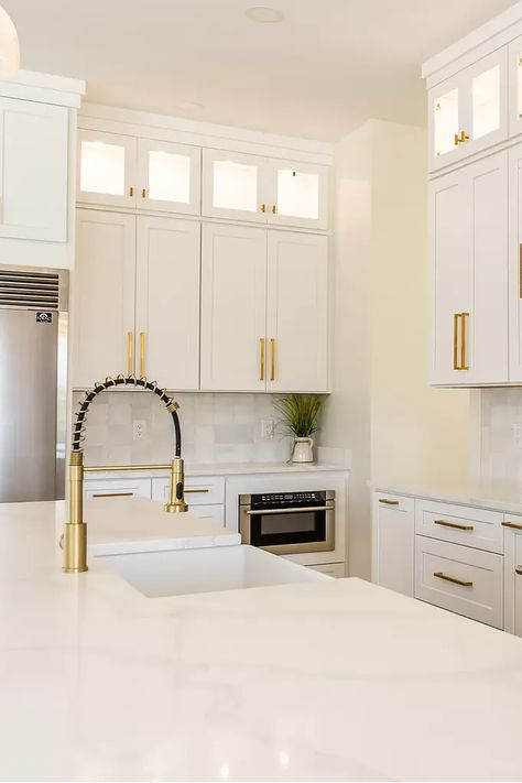 This bright kitchen features white cabinets with gold hardware for a touch of luxury. The butcher block countertops add warmth and contrast, while the open shelving keeps dishes and cookware on display. #kitchen #kitchendesign #whitekitchen #goldhardware #butcherblockcountertops #openshelving #kitcheninspo #dreamkitchen #homedecor #interiordesign #whiteandgold #kitchenmakeover #instahome #homestyling #kitchendecor #luxurykitchen #warmkitchen White Kitchen With Black And Gold Hardware, White Kitchen Cabinets With Gold Pulls, Gold Accents In Kitchen, White And Gold Kitchen Cabinets, Kitchen White Cabinets Gold Hardware, White Cabinets Gold Handles, White Black And Gold Kitchen, White Kitchen Gold Hardware, White Cabinets With Gold Hardware