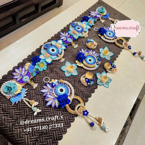 Evil Eye Premium Combo 🧿✨️ 2 Colour options available - Pink and Blue Evil Eye bandhanwar - approx 40 inches Jute base Handwork patches Artificial flowers Evil Eye Shubh Labh Hangings Approx 18 inches length Handwork patches Artificial flowers Cutdana work patches and hangings Rangoli Set of 7 pcs 1 Centre piece 7 inches approx 3 Mirror Handwork t-light holders 3 Jute t-light holders Options With wax With LED #evileye #shubhlabh #bhandwar #diwalidecor #diwali Evil Eye Bandarwal, Bandhanwar Designs, Handmade Decorative Items, Cutdana Work, 3 Mirror, Diwali Decor, Diwali Craft, Diwali Decoration, Dark Art Drawings