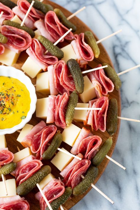 These delish Cuban sandwich skewers are undoubtedly the easiest appetizer ever! All you need to do is layer salami, ham, Swiss cheese, and a mini pickled dill on a skewer, to have yourself a low-carb little Cuban sandwich on a stick. Don't forget to add some dijon mustard for dipping! Best Finger Sandwich Recipes, Club Sandwich Skewers, Ham Decoration Ideas, Cheese And Salami Skewers, Meat And Cheese Toothpick Appetizers, Easy Baby Shower Appetizers, Salami Cheese Skewers, Cuban Sandwich Skewers, Cheese Skewers Appetizers