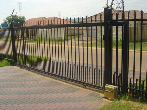 A palisade gate or fence panel is the most popular and demanding choice for getting the high level of security and criminal or thug resistance in the houses, schools, factories, churches, industrial sites, public parks, offices, stadiums, malls, bus terminals and airports. Philippines Fences And Gates, Metal Electric Gates, Security Fence Residential, Electric Gates Entrance Metal, Sliding Gate With Pedestrian Gate, Palisade Fence, Steel Fence Panels, Wrought Iron Gate Designs, Different Types Of Fences