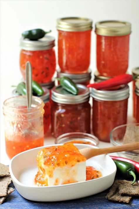 Hot Pepper Jelly is a delight to have in your pantry. Spicy, tangy, and sweet, the jelly is fantastic as an easy appetizer and as a delicious condiment. This recipe is less sweet than usual, but still perfectly balanced in flavor. You can customize the heat level to your liking. Great with cream cheese & crackers as an appetizer, or on sandwiches or burgers, or to glaze meats. #pepperjelly #hotpepperjelly #canningpepperjelly #hotpeppers #jalapenopepperjelly #jalapenos #bellpeppers Canning Pepper Jelly, Cream Cheese Crackers, Zucchini Salsa, Jalapeno Pepper Jelly, Jelly Sweet, Sweet N Spicy, Hot Pepper Jelly, Sweet Recipe, Pepper Jelly