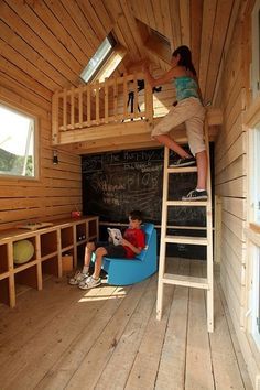 Playhouse is 8 by 9 feet. Built-in cubbies offer plenty of storage for games, toys and other play equipment. A large chalkboard provides a spot for playing school, hosting club meetings and drawing. The blue rocking chair is made of recycled milk bottles. Windows and skylights naturally light the space, but there are also crank lights and a crank radio. Blue Rocking Chair, Playhouse Interior, Kids Clubhouse, Built In Cubbies, Large Chalkboard, Tree House Plans, Backyard Playhouse, Build A Playhouse, Tree House Kids