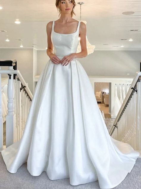 This elegant satin A-line dress is the perfect choice for a destination wedding. Featuring a square neckline, chapel train, and pleated detailing, it offers a truly timeless look. The natural waistline and the built-in bra provide comfortable support and the zipper and covered buttons complete the design. A Line Wedding Dress With Straps, Square Neck Satin Wedding Dress, Dainty Wedding Dress, Simple Classic Wedding Dress, Wedding Dresses Classy, Satin Ballgown Wedding Dresses, Deb Ball, Wedding Dress With Straps, Square Neck Wedding Dress