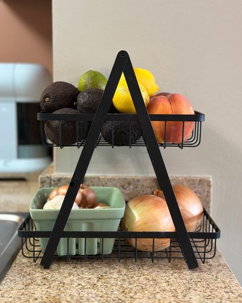 2 tiered fruit and vegetable stand full of fruits and vegetables on counter Fruit And Vegetable Storage Counter, Fruit And Vegetable Storage Countertops, Countertop Produce Storage, Fruit Counter Storage, Fruit Holder Ideas Kitchen, Counter Fruit Storage, Fruit On Counter, Fruit Basket Ideas Kitchen, Fruit Storage Ideas