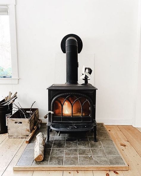 a large vintage black stove on a tile platform is a cool idea to add coziness to your home decor Wood Burning Stove Ideas, Best Wood Burning Stove, Wood Stove Ideas, Stove Hearth, Wood Stove Hearth, Wood Burning Stoves Living Room, Modern Wood Burning Stoves, Modern Stoves, Stove Ideas