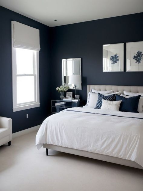 Create a stylish and modern bedroom with a navy accent wall as the focal point. Pair it with a sleek white bed frame and a mirrored dresser for a chic and sophisticated look. One Blue Wall Bedroom, Ink Blue Bedroom, Bedroom With Blue Carpet, Navy Blue White And Grey Bedroom, Navy Walls Bedroom, White And Navy Bedroom, Navy Accent Wall Bedroom, Granny Bedroom, Navy And White Bedroom