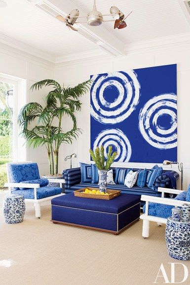 A Gary Simmons painting adds a graphic charge to the pool room; the ottoman, chairs, and sofa are by Aman, Carson & Meeks. The floor lamps are by Ralph Lauren Home, and the rug is from Stark Carpet | archdigest.com Blue Dining Room Decor, Greek Decor, Greek Restaurant, Restaurant Themes, Cat Island, Blue Living Room Decor, Dining Room Blue, Black Dining Room, Blue Living Room