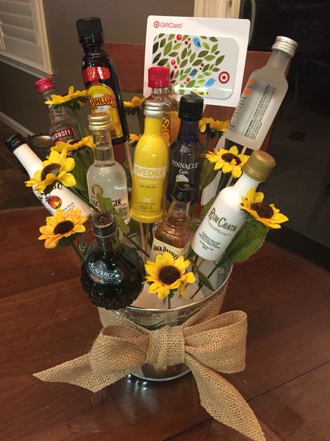 A 21st birthday bouquet! Created using mini bottles of alcohol, skewer sticks, a hot glue gun, some fake flowers, a Styrofoam bottom and a tin bucket! So easy and such a fun gift! Mini Liquor Bottle Bouquet, Liquor Bottle Bouquet, 21st Birthday Bouquet, Alcohol Bouquet, 21st Birthday Basket, Bottle Bouquet, Alcohol Gift Baskets, Liquor Gift Baskets, Liquor Bouquet