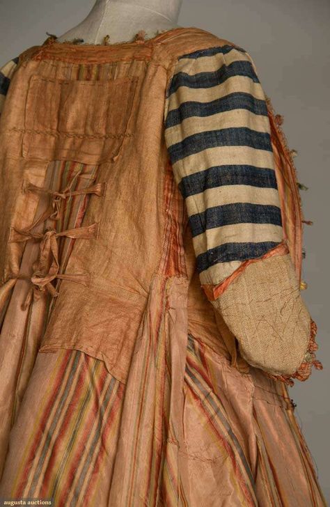 inside of a c1765-1775 sacque-back gown | New York, NY | Shrimp silk, narrow pale ivory stripes brocaded w/ scattered floral baskets & sprigs, elbow length sleeves, self ruched fabric w/ fly fringe edge trims sleeves & dress front opening, multi-color striped silk lining, dull red linen bodice lining w/ 3 CBties, sleeve linings in ivory & navy wide striped linen homespun | Augusta Auctions 18th Century Gown, 1700 Fashion, 18th Century Women, Augusta Auctions, 18th Century Dress, 18th Century Costume, 18th Century Clothing, 18th Century Fashion, Floral Baskets