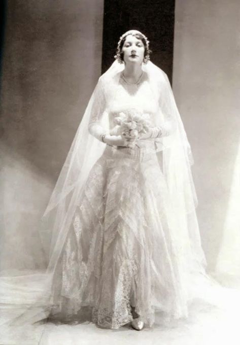 Chanel Wedding Dress ca. 1930 —- Betty Garst wearing a wedding dress, from Chanel, stiffened lace and tulle with long sleeves and a ruffled skirt. Chanel Wedding Dress, Look Gatsby, Chanel Wedding, 1920s Wedding Dress, 1930s Wedding, 1920s Wedding, Vintage Wedding Photos, Antique Wedding, Wedding Gowns Vintage